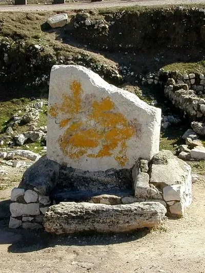 The standing stone at Shechem — a large upright stone with lichen markings, set on a stone base amid ancient ruins, identified by Egyptologist David Rohl as the cultic stone erected by Joshua