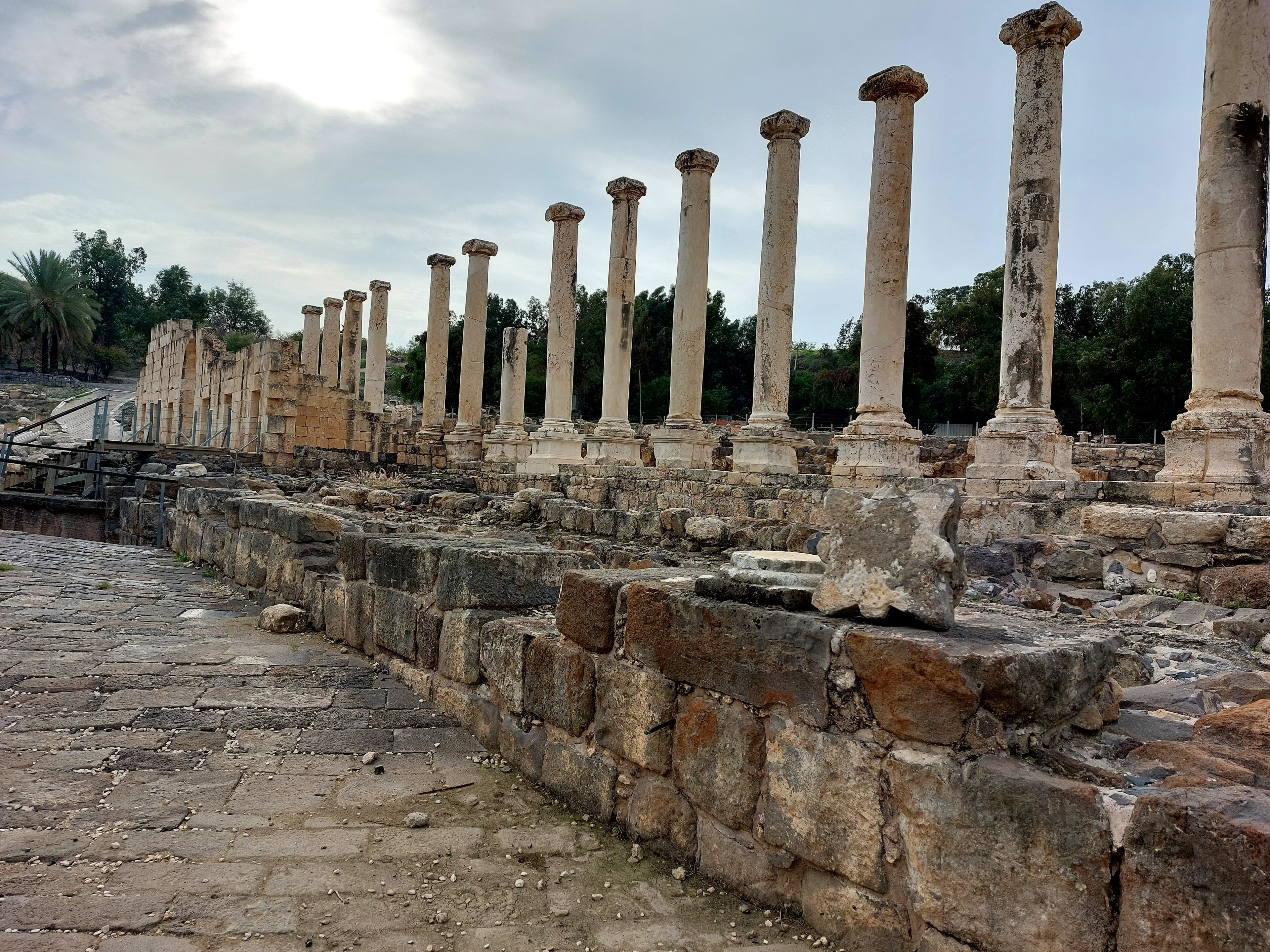 Ancient Roman market street at Beth-Shan with rows of standing columns lining the stone-paved road