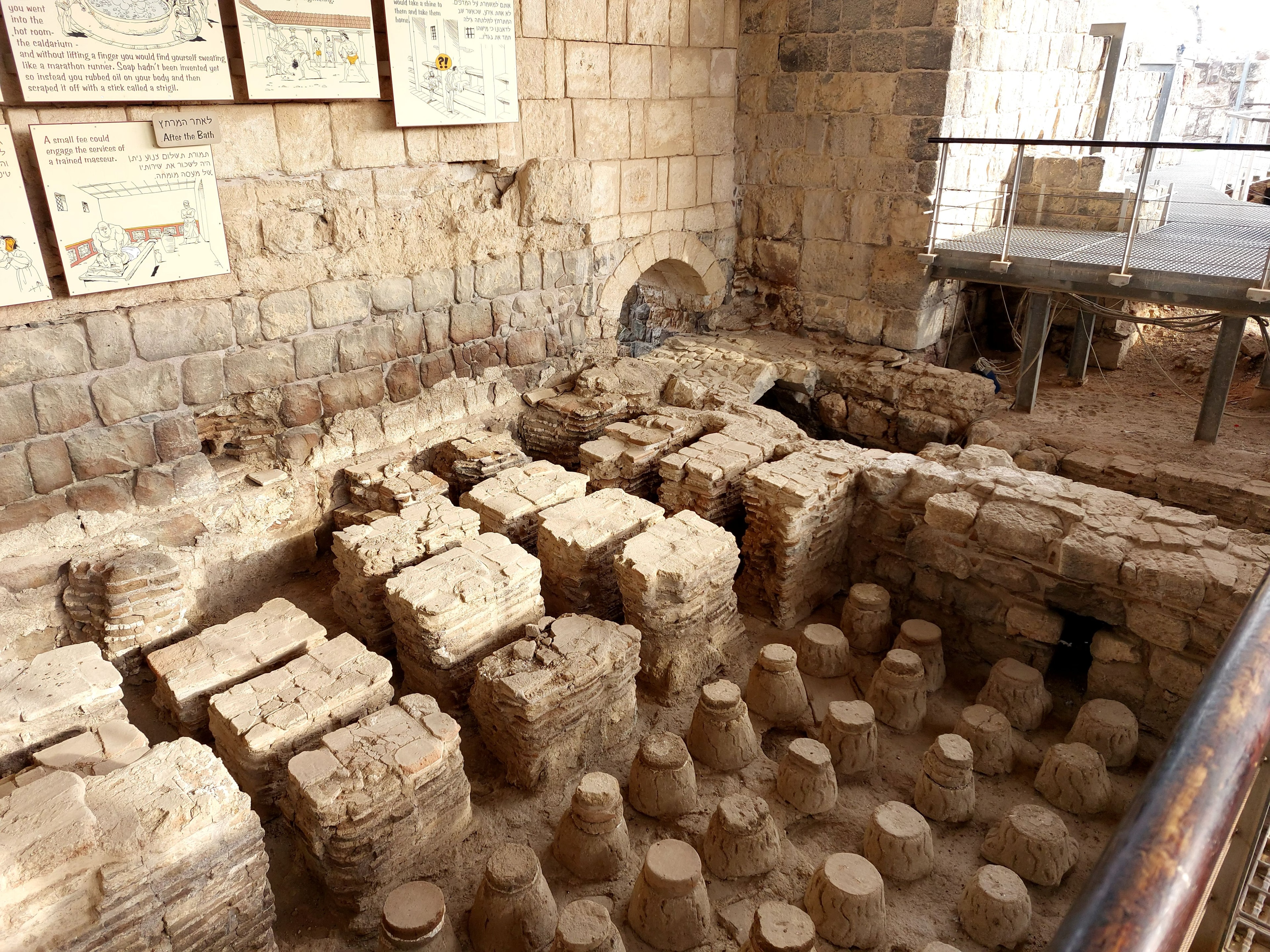 Excavated ruins of the Roman public baths at Beth-Shan showing hypocaust pillars and floor supports used to circulate hot air beneath the bathing rooms