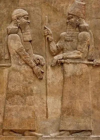 Ancient Assyrian stone relief depicting two royal figures from the era of Sargon II, king of Assyria